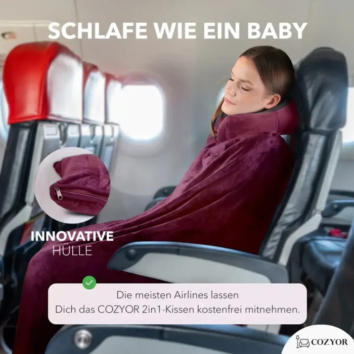 Eine Frau schläft im Flugzeug mit einer weichen, dunkelroten Reisedecke und einem Nackenkissen. Nahaufnahme des Reissverschlusses der Deckenhülle.