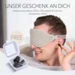 Schlafmaske und Ohrstöpsel im Set. Ein Mann trägt eine beige Schlafmaske und setzt sich ein Paar wiederverwendbare Silikon-Ohrstöpsel ein, während eine geöffnete Aufbewahrungsbox mit weiteren Ohrstöpseln zu sehen ist.